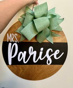 a wooden sign that says, mrs parise with a green bow on the top