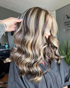 Discover a medium-length hairstyle where art meets fashion, blending luscious waves with chunky blonde highlights over a dark base. The layers are designed for bounce, showcasing a smooth color transition from crown to tips. Ideal for those seeking dynamic contrast with a natural flow. Inspired? Click for our gallery and follow us on Pinterest for more vibrant looks! ** Photo Credit: Instagram @ha1r.by.tay Long Hair Chunky Highlights, How To Do Chunky Highlights, Soft Chunky Highlights, Long Brown Hair With Chunky Blonde Highlights, Bronde Balayage Chunky, Long Sleek Hair, Medium Length Wavy Hair, Chunky Highlights