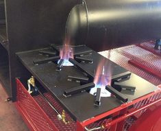 two burners on the back of a red cart