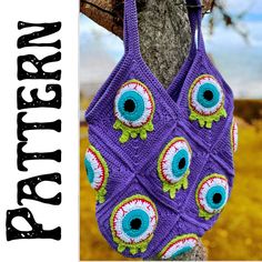 a crocheted bag hanging from a tree with an evil eye pattern on it