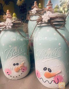 two blue jars with snowmen painted on them