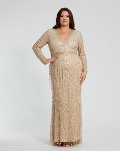 a woman in a gold sequin dress with her hands on her hips, posing for the camera