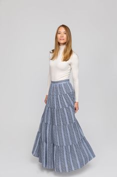 Meet our Lily Skirt. This is going to be your go-to skirt! In the perfect cornflower blue color, we love this skirt for its' pockets and flowy style. Pair it with sneakers and a white top for easy Saturday errands or dress it up with a pair of heels and a blouse for a night out on the town. We see you wearing this skirt from a girls' night out to dinner with the family! It is so comfortable and easy to wear. Details Fabric: 60% rayon 35% polyester Multi-tiered maxi length Back zipper closure Fab Blue Flowy Bottoms For Spring, Modest Tiered Pleated Skirt, Spring Blue Flowy Skirt, Light Blue Casual Ruffled Skirt, Blue Flowy Skirt For Spring, Casual Light Blue Ruffled Skirt, Light Blue Flared Casual Skirt, Light Blue Lined Tiered Skirt, Light Blue Casual Flared Skirt