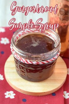 a glass jar filled with chocolate sauce on top of a wooden board