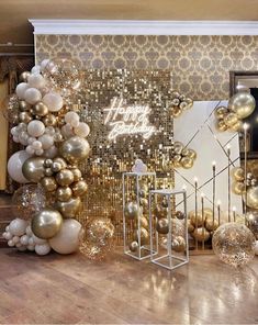 a room filled with lots of gold and white balloons