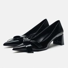 Block Heel Pumps. Faux Patent Leather Finish. Front Bow Embellishment. Pointed Toe. Heel Height: 2.1 Inches (5.3 Cm) Black Glamorous Black Heels With Bow, Elegant Bow Heels For Fall, Black Glamorous Heels For Work, Black Glamorous Heels, Elegant Black Heels For Office, Elegant Black Heels For The Office, Glamorous Black Heels For Work, Elegant Black Office Heels, Elegant Black Synthetic Heels