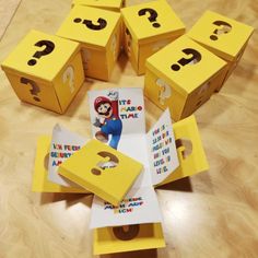 several boxes with question marks on them sitting on a wooden floor next to each other