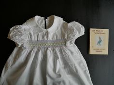 An authentic vintage dress C.1950s in great condition. I'm not sure what the fabric content is as there are no labels but it washed well. Has a pretty Peter Pan collar, three button fastening at the back, gathering puff short sleeves and a panel of pretty smocking in pastel colours. The dress measures 24" long and 24" across the chest.  Very sweet and in good condition.Postage rates between UK and USA have risen dramatically since 01.07.20. If you are buying from USA, please contact me as I may Vintage Girls Dresses, Pastel Colours, Vintage Girls, Pan Collar, Dress C, Peter Pan Collar, Vintage Dress, True Vintage, Peter Pan