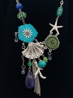 Dive into the beauty of the ocean with our Aquatic Treasures Charm Chain Necklace! Featuring a delicate chain adorned with vibrant charms inspired by sea life, this necklace will add a touch of whimsy and elegance to any outfit. Make a splash and express your love for the ocean with this one-of-a-kind accessory! Bohemian Blue Starfish Charm Jewelry, Bohemian Blue Jewelry With Starfish Charm, Ocean-inspired Turquoise Necklace With Starfish Charm, Turquoise Ocean-inspired Necklace With Starfish Charm, Ocean-inspired Pendant Necklace With Lobster Clasp, Turquoise Necklace With Starfish Charm, Whimsical Green Charms Jewelry, Whimsical Green Jewelry With Charms, Ocean-inspired Turquoise Necklace With Lobster Clasp