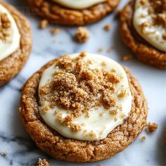 cookies with white frosting and crumbs on top