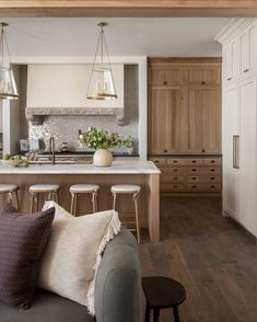 a living room filled with furniture and lots of counter top space next to a kitchen