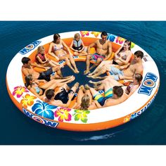 a group of people floating on top of an inflatable boat