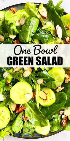 a salad with green vegetables and nuts in it is on a plate that says, one bowl green salad