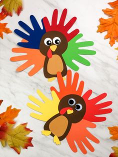 paper turkeys on marble with fall leaves