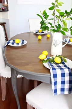 a dining room table with plates and lemons on it