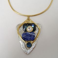 Large Chunky Blue & Crystal Pendant Necklace By J. Jansen. Unique Necklace In Clear Crystal & Shades Of Blue Colored Semi-Precious Stones. Plated In 24 Kt Gold & A Non-Tarnish Silver Finish. Adjustable Length From Approx. 14" To 16". New With Tag. 100 407 263 Luxury Blue Jeweled Necklaces, Modern Blue Necklaces For Parties, Modern Blue Necklace For Party, Modern Blue Metal Necklaces, Modern Blue Metal Necklace, Modern Blue Gemstone Necklace, Modern Blue Pendant Jewelry, Blue Crystal Pendant Necklace, Elegant Blue Crystal Necklace With Gemstone Accents