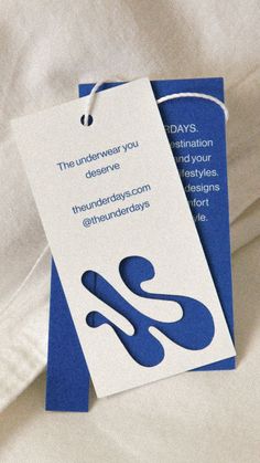 two blue and white tags with words on them