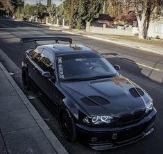 a black car parked on the side of a street