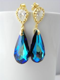 "Handmade Sterling Silver Earrings feature sparkly Blue Swarovski drops. These beautiful earrings are made of Crystallized Elements Drop Briolettes that hang from Gold over Sterling post earrings with clear Cubic Zirconia Drops. They are perfect for a fancy night. The colors will catch everybody's eyes and gorgeous as focal point of your outfit. Also great for Bridesmaids sets. Contact me for larger orders. The Swarovski crystals measure 24 mm (1 inch)and the whole earrings including the Gold Ea Blue Pear-shaped Teardrop Earrings For Wedding, Blue Teardrop Wedding Earrings, Blue Drop Bridal Earrings For Wedding, Blue Teardrop Crystal Earrings For Wedding, Blue Crystal Teardrop Bridal Earrings, Blue Pear-shaped Wedding Earrings, Blue Crystal Teardrop Earrings, Blue Long Drop Jewelry For Wedding, Blue Long Drop Wedding Jewelry