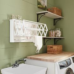 a washer and dryer sitting next to each other in a room with green walls