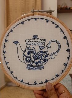 a hand embroidered picture of a tea pot