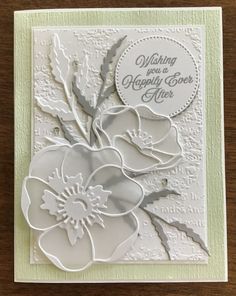 a card with white flowers on it and the words wishing you a happy new year