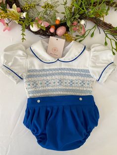 Pre-order handmade smocked romper. Thank you for your patience and for supporting a small business. Clothing Care Instructions Most items can be washed safely in cold water on delicate cycle and hung to dry. If the item that you are ordering has red or another bright color in it next to a white or other light color fabric please use a Shout color catcher for the first few washes to avoid bleeding. The reds are pre-washed but they are still red and will likely have some color transfer without a c Cotton Fitted Bubble Romper With Smocked Back, Spring Bubble Romper With Smock Detail, Spring Fitted Smocked Bubble Romper, Spring Fitted Smock Bubble Romper, Fitted Smock Bubble Romper For Summer, Cute Fitted Smocked Dress With Smocked Cuffs, Baptism Smocked Dress With Short Sleeves, Baptism Short Sleeve Smocked Dress, Small Business Clothing