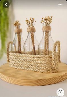 an empty glass bottle is sitting on a wooden tray with rope wrapped around the bottles