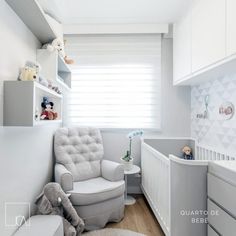 a baby's room with white walls and furniture