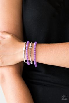 Mismatched silver beads and strands of glassy purple beads are threaded along stretchy bands. Infused with silver accents, dainty rose blossoms adorn the wrist for a seasonal finish.

Sold as one set of four bracelets. Dainty Rose, Purple Beads, Purple Bracelet, Silver Frames, Rock Stars, Paparazzi Accessories, Stretchy Bracelets, Paparazzi Jewelry, Flower Charm