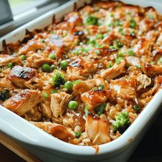 a casserole dish with chicken, peas and rice