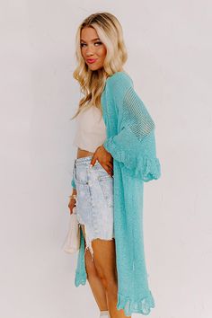 Relax in the summer evening breeze with this cute turquoise cardigan featuring lightweight knit material, oversized half sleeves, ruffle trim detailing, and a draped open front silhouette that falls into a straight mid-calf length hemline! Measurements S : Bust 46", Hip 44", Length 38", Sleeve Length 19", Waist 44". M : Bust 48", Hip 46", Length 39", Sleeve Length 19", Waist 46". L : Bust 50", Hip 46", Length 39", Sleeve Length 19.5", Waist 46". Turquoise Cardigan, Summer Cardigan, Distressed Shorts, Summer Evening, Model Fits, Women Clothing Boutique, Lightweight Knit, Hip Length, Ruffle Trim