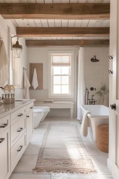 a large bathroom with white fixtures and wooden ceiling