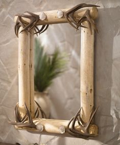 a mirror with antlers hanging on the wall