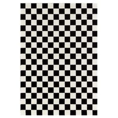 a black and white checkered rug on a white floor with an area rug in the middle