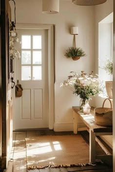 the sun shines through the window into a hallway with plants on the wall and a bench