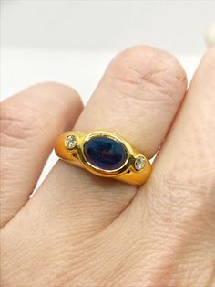 GORGEOUS 18KYG Oval Cabochon Sapphire & Diamond East-West Bezel Ring Size 5.25 18K Yellow Gold Band East-West Bezel Ring 1 Beautiful Oval 7.47mm  x 5.41mm Cabochon Sapphire 2 Round Diamonds on each side weighing 0.20 Carats total carat weight of G-H/VS2 Quality 6.7 grams total ring weight Size 5.25 Ships from Cleveland, Ohio. Comes with complimentary polishing cloth from DeWitt's. Bezel Signet Ring, Bezel Set Alexandrite Ring, Unique Ring Setting, Blue Stone Ring, Alexandrite Ring, Bezel Ring, Birthday Ring, Cabochon Ring, Pink Ring