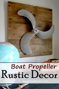 a boat propeller is mounted on the wall above a wooden sign that says rustic decor