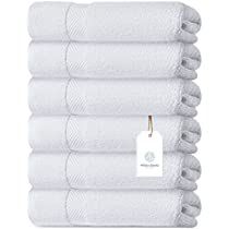 six white towels stacked on top of each other with a price tag attached to them