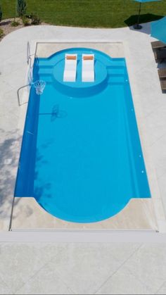 an above ground swimming pool with lounge chairs