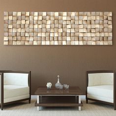 a living room with two chairs and a coffee table in front of a wall sculpture