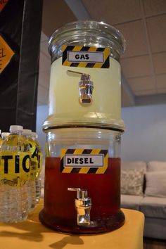 three containers with gas and diesel labels on them