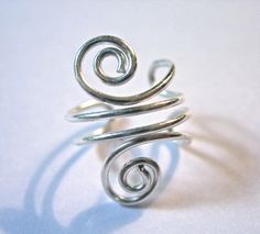 "For your consideration is a beautiful solid sterling silver ear cuff with double swirls made from .925 20g Sterling Silver. Simple and versatile, very elegant. Can be worn on the right or left side. Adjustable, so you can tighten or loosen it to suit you. Wear this up toward the top of your ear or slide it down closer to the ear lobe. Ear cuffs fit on the edge of your ear and do not require you to have pierced ears, but can be worn with piercings if desired. All of my items are 100% handmade by Silver Spiral Adjustable Ear Cuff, Elegant Silver Spiral Ear Cuff, Silver Ear Cuffs, Wrap Earrings, Silver Ear Cuff, Ear Cuffs, On The Edge, Pierced Ears, Ear Piercings