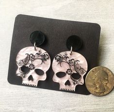 Inspired by the goddess Persephone, these earrings are the perfect mix of dark and gothic, while still exuding touches of spring and growth. Available on sterling silver or hypoallergenic stainless steel studs. Punk Skull Print Earrings Gift, Punk Skull Print Earrings For Gift, Punk Style Skull Print Earrings As Gift, Edgy Skull-shaped Earrings For Gift, Edgy Skull Shaped Earrings For Gift, Gothic Skull Print Earrings For Gift, Gothic Skull Print Earrings As Gift, Black Skull Earrings For Gift, Nickel-free Emo Earrings For Gift