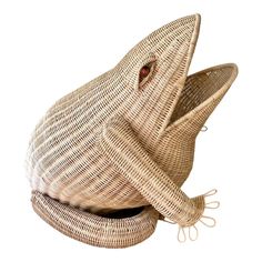 a bird shaped basket sitting on top of a white surface