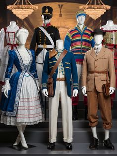 A stunning collection of French traditional clothing displayed on mannequins, showcasing the rich history and cultural heritage of France. The outfits include the iconic Marie Antoinette dress with a powdered wig, a 19th-century military uniform, a colorful Breton fisherman's attire, and a classic Parisian street fashion ensemble from the early 20th century. The background features a sophisticated French cafe ambiance, with elegant chandeliers and a warm, golden glow. French Revolution Aesthetic Clothes, French National Costume, Parisian Street Fashion, Traditional Costumes Of The World, Post French Revolution Fashion