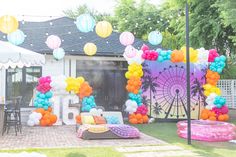 an outdoor party with balloons and decorations