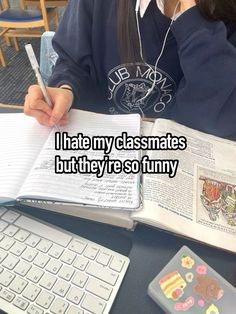 a person sitting at a desk with an open book and pen in front of them