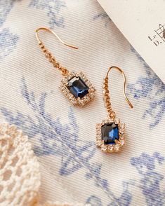 Experience the beauty of these Renaissance Earrings, featuring faux glass sapphires. These stunning earrings are sure to add a touch of elegance to any ensemble. Perfect for special occasions or everyday wear. Sapphire faux glass gold plated brass earrings. Exquisite Crystal Drop Earrings, Jeweled Gold-plated Drop Earrings, Jeweled Drop Earrings For Celebrations, Timeless Evening Earrings With Gemstone, Timeless Gemstone Earrings For Evening, Formal Bridal Gemstone Drop Earrings, Formal Bridal Drop Earrings With Gemstones, Timeless Gemstone Earrings For Formal Occasions, Elegant Crystal Jewelry With Plating