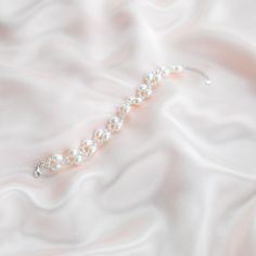 The Handmade Twist Oval Pearls Bracelet is a unique and stunning piece of jewelry that matches well with any bridal dress or other daily outfit. Made by skilled artisans, this bracelet features a twist design that adds a touch of elegance to the smooth and lustrous oval-shaped pearls. The pearls are hand-selected for their quality and color, ensuring that each bracelet is one-of-a-kind. Pearl Type: Freshwater Pearls Pearl Quality: [Shape]: Oval Shape [Pearl Size]: 6-7mm [Blemish]: Minor [Luster] Handmade Adjustable Pearl Bracelet For Wedding, Delicate Pearl Bracelets For Formal Occasions, Elegant Crystal Bangle Bracelet, Formal Delicate Pearl Bracelets, Elegant Bracelet Jewelry For Bridesmaid Gift, White Feminine Bracelets For Wedding, Delicate Wedding Jewelry With Oyster Bracelet, Delicate Oyster Bracelet Jewelry For Wedding, Delicate Handmade Beaded Bracelets For Wedding